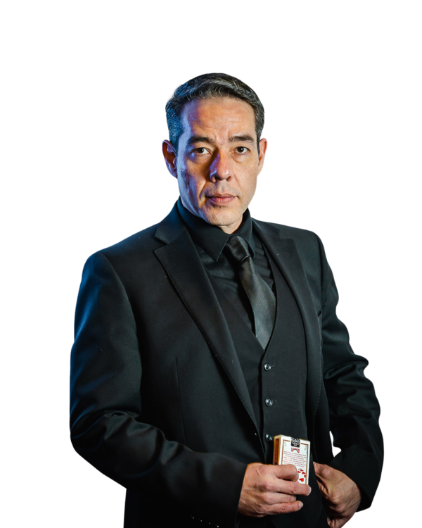 Gozner in a black suit holding a deck of cards, portrait